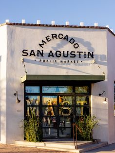 the entrance to an upscale public market called mercado san agoustin in santa fez, mexico