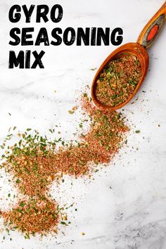 a wooden spoon filled with spices next to a pile of ground flakes on top of a white counter