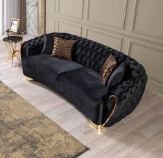 a black velvet couch with gold accents and leopard print pillows on the armrests