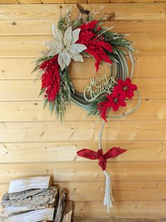 a christmas wreath with poinsettis hanging on the wall