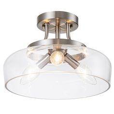 a semi flush ceiling fixture with clear glass and metal accents, on an isolated white background