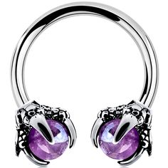 an image of a pair of piercings with purple stones