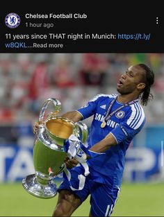 a soccer player holding a trophy on the field