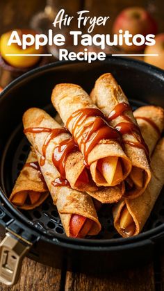 an air fryer filled with apple taquitos