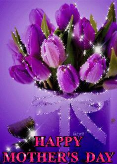 purple tulips in a glass vase with sparkling lights on the top and bottom