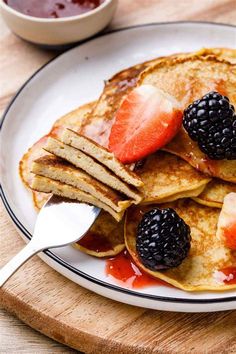 pancakes with fruit and syrup on a plate