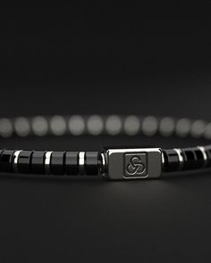 Embrace the power and sophistication of the Onyx Bracelet from the Spacer #2 Collection. This exquisite piece combines the strength of onyx with refined design, creating a timeless and stylish accessory for any occasion. Design and Materials: Onyx Beads: Featuring smooth 4mm circular onyx beads, this bracelet showcases the deep, captivating essence of onyx, known for its protective and grounding properties. Circular Gold Plated Spacers: Interspersed with delicate gold-plated spacers, the bracele Timeless Adjustable Black Jewelry, Modern Adjustable Black Sterling Silver Bracelet, Elegant Adjustable Black Sterling Silver Bracelet, Classic Black Onyx Bracelets, Modern Black Sterling Silver Bracelet, Classic Black Beaded Bracelets, Classic Black Sterling Silver Jubilee Bracelet, Classic Black Onyx Bracelet, Luxury Silver Onyx Bracelets