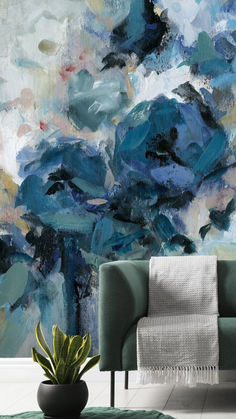 a living room with a couch, rug and painting on the wall behind it in blue tones