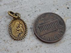 Religious antique French vermeil gold plated medal pendant medaillon medallion of Holy Mary Our Lady with Child Jesus and Holy Christ. The measures of the vermeil gold plated medal with loop are : 0,43 x 0,66 inches ( 1,09 x 1,68 cm ) I bought the medal on a brocante ( fleamarket ) in France. I deliver all over the world. Registered shipping is possible and is costing 22 US dollars. If you haven't Paypal, you can pay by bank transfer. I have a lot of this medals. If you have a question feel free Commemorative Coin Pendant, Gold Medallion Charms With Coin Pendant, Antique Brass Charms For Collectors, Antique Finish Gold Jewelry For Commemoration, Gold Antique Finish Jewelry For Commemoration, Vintage Gold Round Pendant Charm, Victorian Gold Pendant Charms, Antique Gold Charms For Collectors, Antique Gold Charms