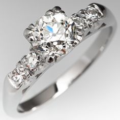 a three stone diamond ring on a white background