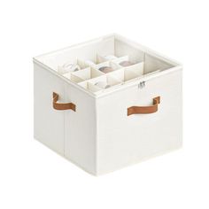 a white storage box with brown handles and compartments on the bottom, filled with empty cups