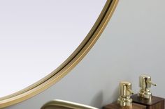 a bathroom sink with gold faucet and soap dispenser next to it