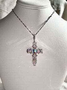 Dolce Diamond CZ Cross Necklace with Chain with 14k White Gold or 14k Yellow Gold option. Center stone is Rainbow moonstone surrounded by cubic zirconia diamond stones.  Perfect Bling statement piece. Satellite Chain with custom length between 16-17.5 in.  High Quality Gold Filled, not cheaper Gold Plated.  Gold-filled jewelry offers greater durability, thicker gold layer, and longevity.  Less prone to chipping and tarnishing like the other cheaper gold alternatives. I'm happy to assist! Please Wedding Cross Jewelry In Cubic Zirconia, Wedding Cross Necklace In Cubic Zirconia, Wedding Cubic Zirconia Cross Jewelry, Wedding Jewelry: Cubic Zirconia Cross Pendant, Cubic Zirconia Cross Pendant Jewelry For Weddings, Cubic Zirconia Cross Pendant For Wedding, Elegant Cross-shaped Jewelry, Diamond Cross Necklace, Jewelry Fashion Trends