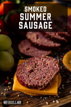 sliced meatloaf on a cutting board with grapes and tomatoes in the background text reads smoked summer sausage