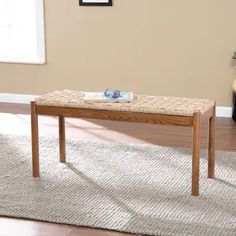 a wooden bench sitting on top of a rug