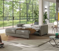 a modern living room with large windows and furniture in it's centerpieces