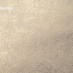 an image of a textured surface with roses on it in gold and silver colors