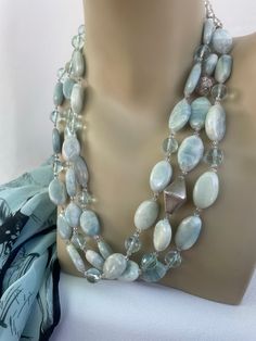 Handmade Aquamarine Necklace, hand-knotted in grey silk thread, triple strand of milky aquamarine nuggets, faceted 8 mm aqua quartz, 3 mm Swarovski crystal, 1 antique Venetian Bead, 6 mm rock crystal in back of necklace for comfort and style. This handmade, one off necklace is embellished with sterling silver findings and toggle, length of necklace is 22 inches, weight is 6.6 oz, hand-crafted in North Palm Beach, Florida by designer artist Christine Smith. Aqua Stone, Aquamarine Gem, Jewerly Diy, Artisan Bracelets, Stone Beaded Necklace, Aquamarine Necklace, Aquamarine Jewelry, Antique Necklace, Venetian Glass