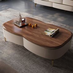 a coffee table with an oval shaped top and two drawers on each side, in a living room