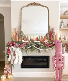 a fireplace decorated for christmas with pink decorations