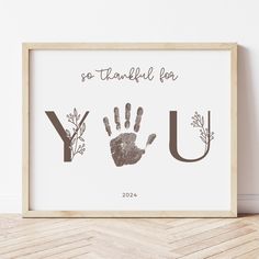 a framed print with the words you and hand prints