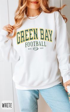 Get ready to show your unwavering support for Green Bay football with this sweatshirt. Whether you're cheering from the stands or watching from home, this cozy and stylish sweatshirt is the perfect way to represent your team. Made from high-quality materials, it's not just comfortable, but it also lets you wear your football pride loud and clear. As a fan, you understand the importance of tradition, and our sweatshirt embodies that spirit. Join the Packers' faithful and gear up for game day with Cheap Green Sweatshirt For Game Day, Cheap Green Sweatshirt For Sports Events, Cheap Crew Neck Tops For Football Season, Cheap Football Season Fan Gear Sweatshirt, Varsity Letter Print Sweater For Game Day, Crew Neck Letter Print Sweater For Game Day, Green Long Sleeve Sweatshirt For Game Day, Relaxed Fit Sweatshirt For College Football Season, College Sweatshirt With Letter Print For Football Season