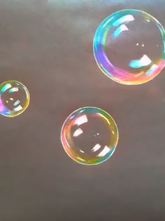 three soap bubbles floating in the air