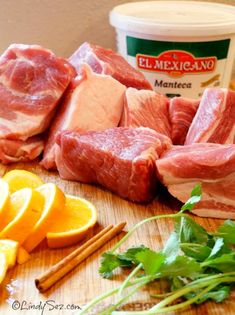 some meat and oranges on a cutting board