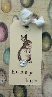 a brown and white tag with an image of a bunny on it that says honey bun