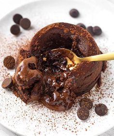 a chocolate dessert with ice cream and chocolate chips on a white plate, ready to be eaten