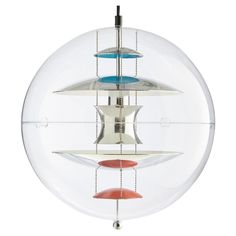 a circular object with three different colored objects in it's center, hanging from the ceiling