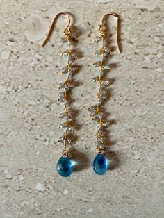 Aquamarine Earrings featuring a stunning rare dark blue aquamarine tear drop stone accented with a mystic coated labradorite rosary chain.  Gold filled ear wires.  Earrings measure 3 inches.  Handmade. GIFT BOXED Dangly Earring, Hoco Inspo, Blue Stone Earrings, Aquamarine Earrings, Rosary Chain, March Birthstone, Dangly Earrings, Aquamarine Gemstone, Chain Gold