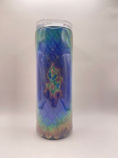 a blue and green vase with an intricate design on it