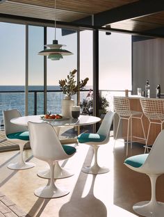 an image of a dining room setting with ocean view