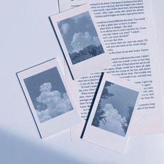 three polaroid photos sitting on top of an open book with the pages torn off