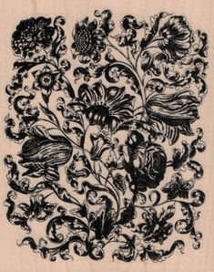 a black and white drawing of flowers on a piece of wood with swirly designs