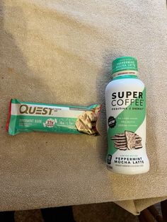 a bottle of quest coffee next to a bar of peanut butter on a chair cushion