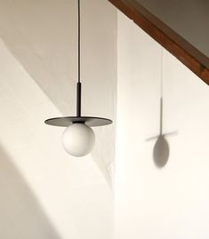 two white balls are hanging from the ceiling