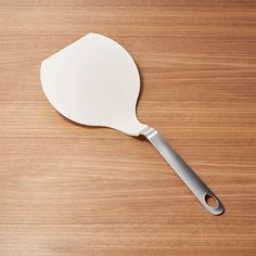 a white spatula sitting on top of a wooden table