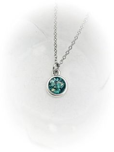 This beautiful, dainty necklace is made using your beloved pet's actual ashes. You may or may not be able to see the ashes, as I add a touch of glitter to highlight the piece. If it is important for you to see the ashes, please state this in a note during checkout.The rhodium plated silver disc pendant is approximately 1/2" and graces a dainty stainless steel link chain. The stone color in photo 1 is a clear stone with the ashes visible. All ashes vary in color. This is only an example.  Please Silver Hypoallergenic Necklace For May Birthstone, Pet Cremation Jewelry, Cremation Ring, Ashes Necklace, Cremation Necklaces, Memorial Ring, Pet Memorial Jewelry, Pet Cremation, Ashes Jewelry