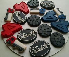 there are many decorated cookies in the shape of cars and trucks on this plate,