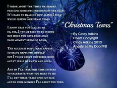 a christmas poem with blue ornaments hanging from a tree branch in front of a dark background