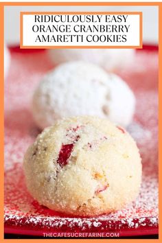 three cranberry cookies sitting on top of a red plate with the words ridiculous easy orange cranberry amaretti cookies