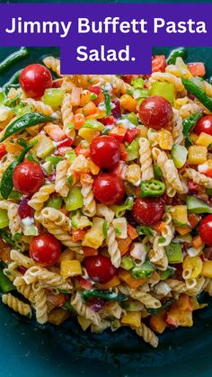 a bowl filled with pasta salad on top of a blue plate