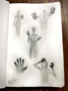 an open book with drawings of hands coming out of it