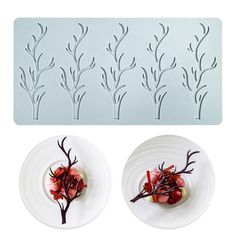 two white plates with food on them next to a stencil set that looks like tree branches