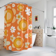 an orange shower curtain with white and yellow flowers on it in a bathroom next to a bathtub