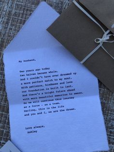 a piece of paper with a poem written on it next to a note and envelope