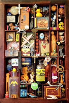 a wooden box filled with lots of different types of bottles and magnets on top of it