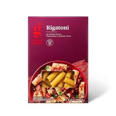 rigatoni pasta in a red bowl on a white background